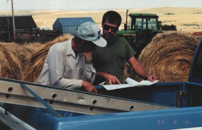 In 1999, Brother Placid Gross (left) went over the farm seeding and management with Farm Service Agency representative, Darin Naumann.